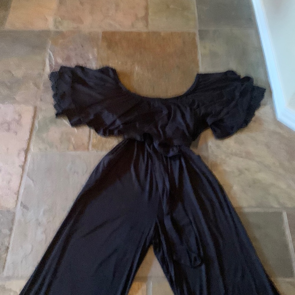 Beautiful black, off the shoulder jumpsuit with multi layers of ruffles.